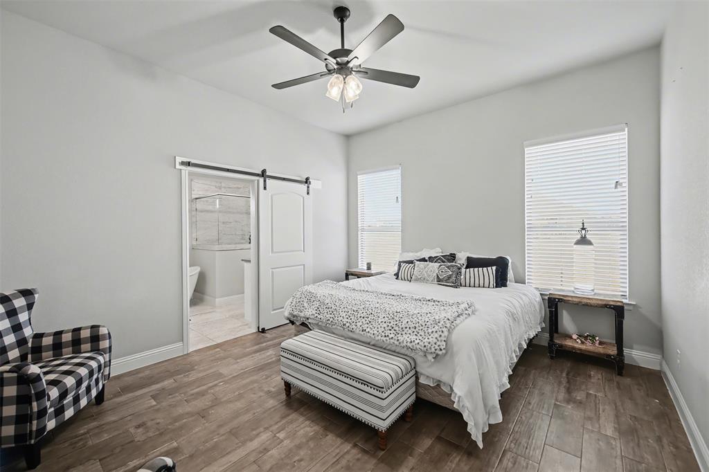 6334 Rustic Edge Street Godley, TX 76044 - Photo 10 of 26 a bedroom with a bed and a table with chair