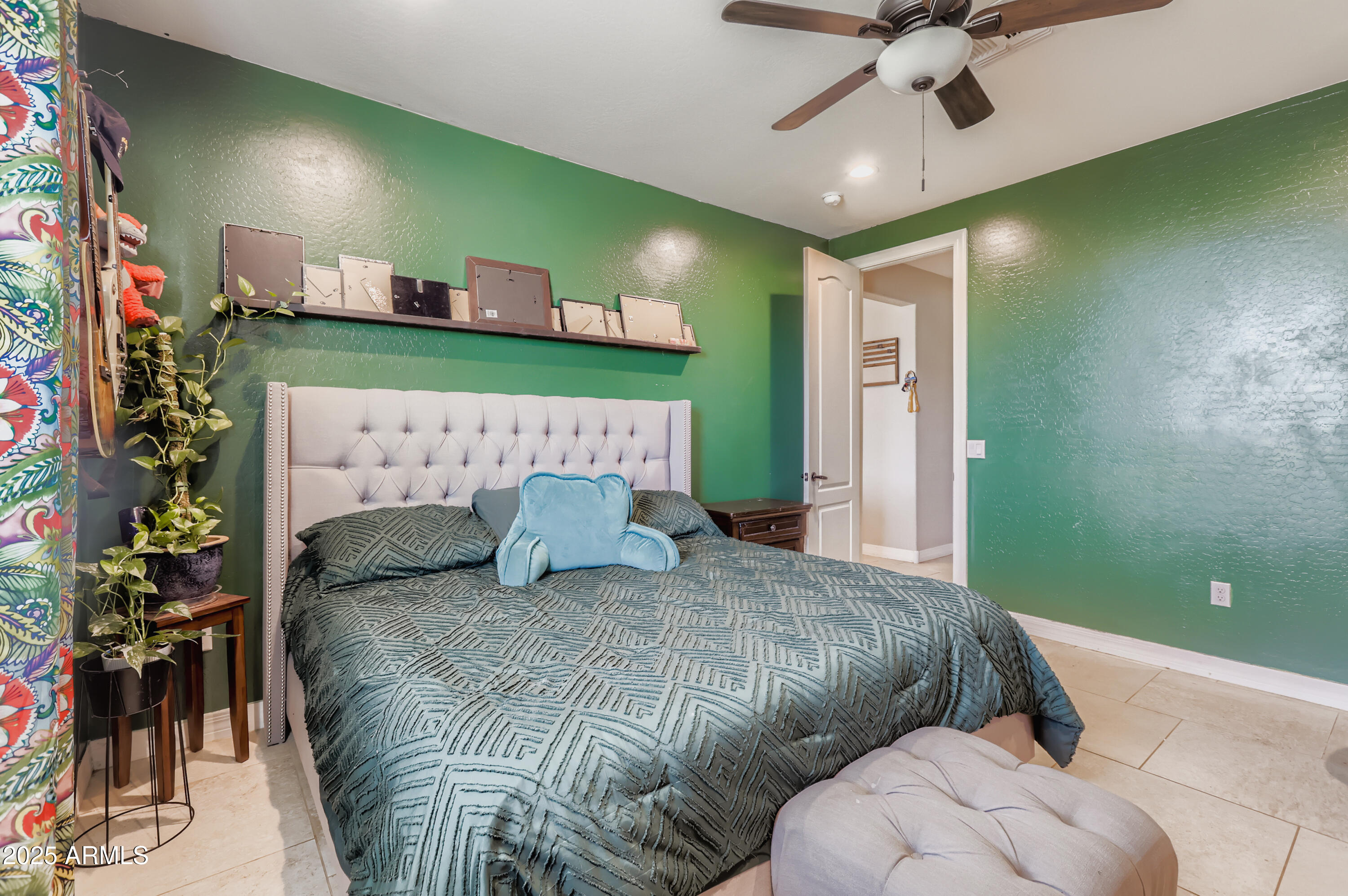 22136 West Gambit Trail Wittmann, AZ 85361 - Photo 15 of 38 a bed room with a bed and a chandelier