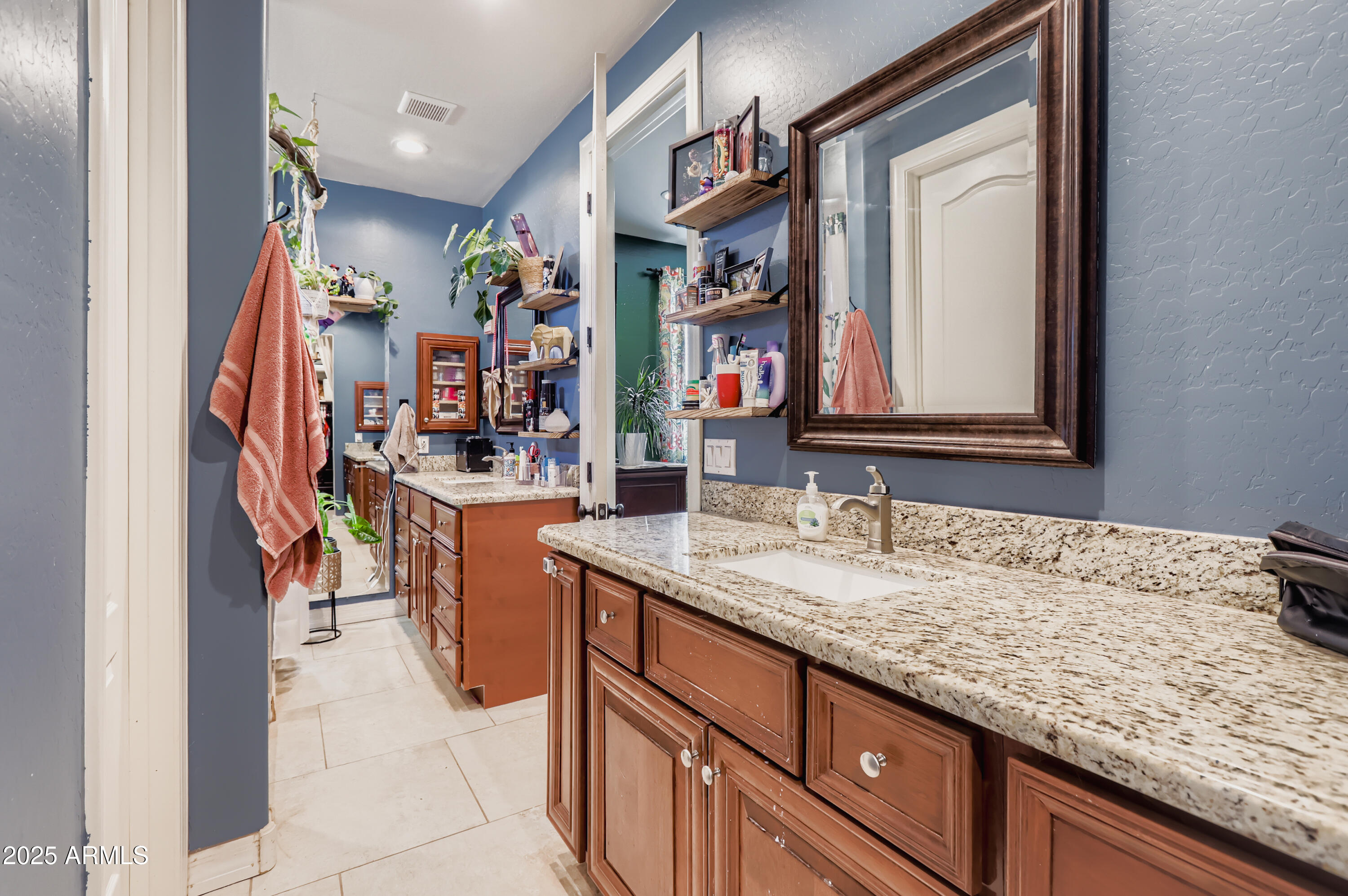 22136 West Gambit Trail Wittmann, AZ 85361 - Photo 18 of 38 a bathroom with a sink vanity and mirror
