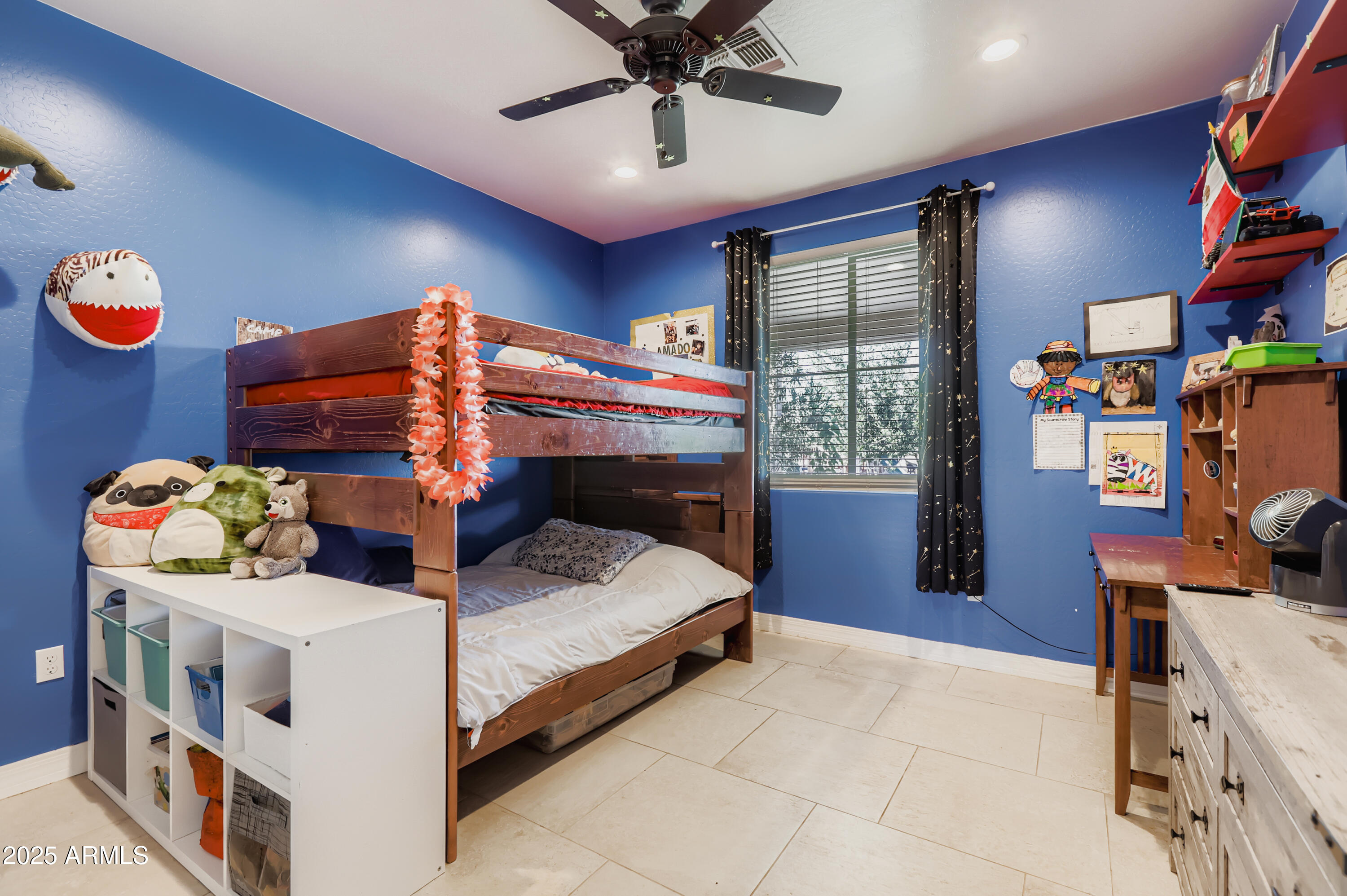 22136 West Gambit Trail Wittmann, AZ 85361 - Photo 19 of 38 a bedroom with bed and a chandelier