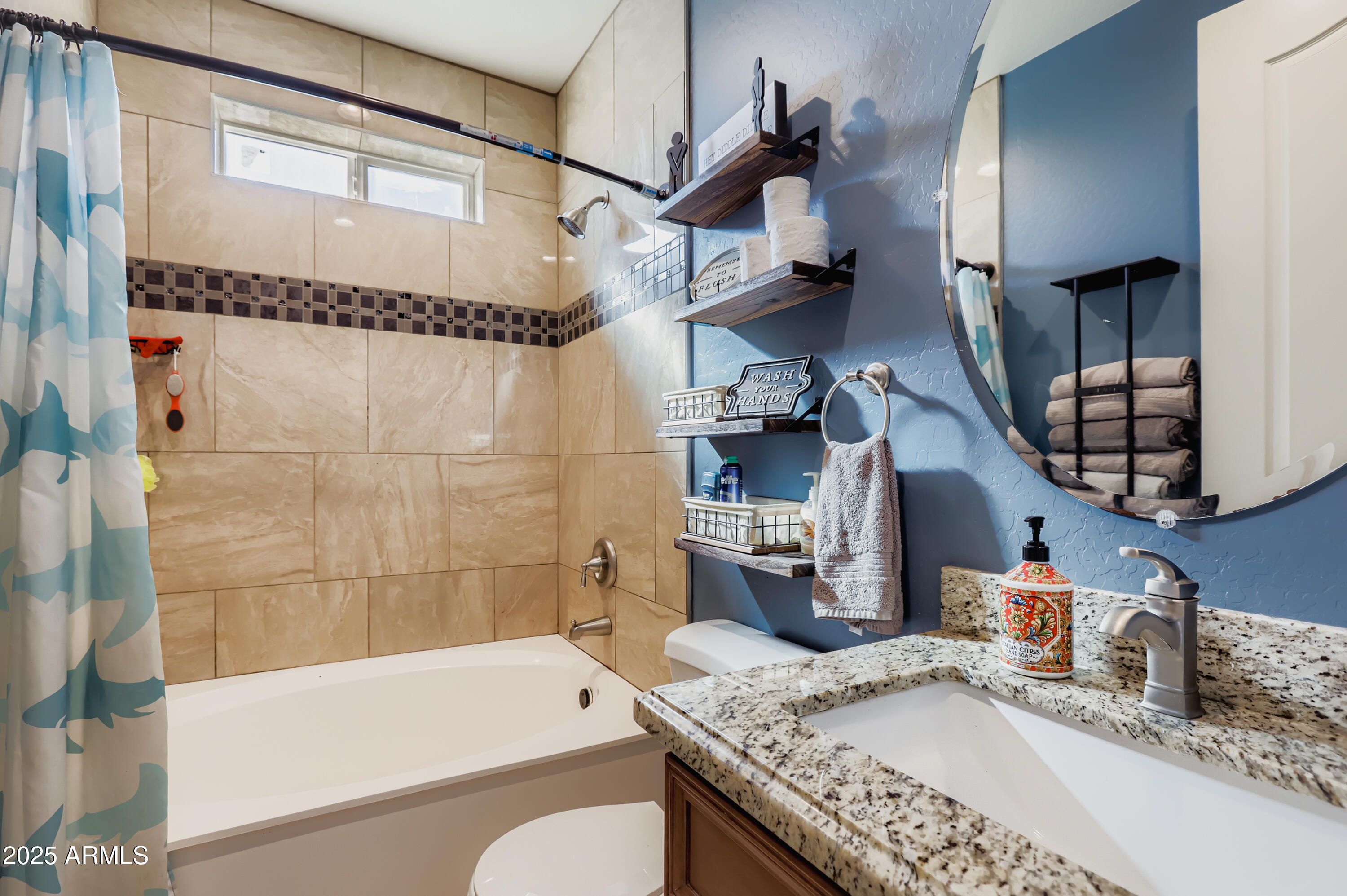22136 West Gambit Trail Wittmann, AZ 85361 - Photo 20 of 38 a bathroom with a granite countertop sink a toilet and bathtub