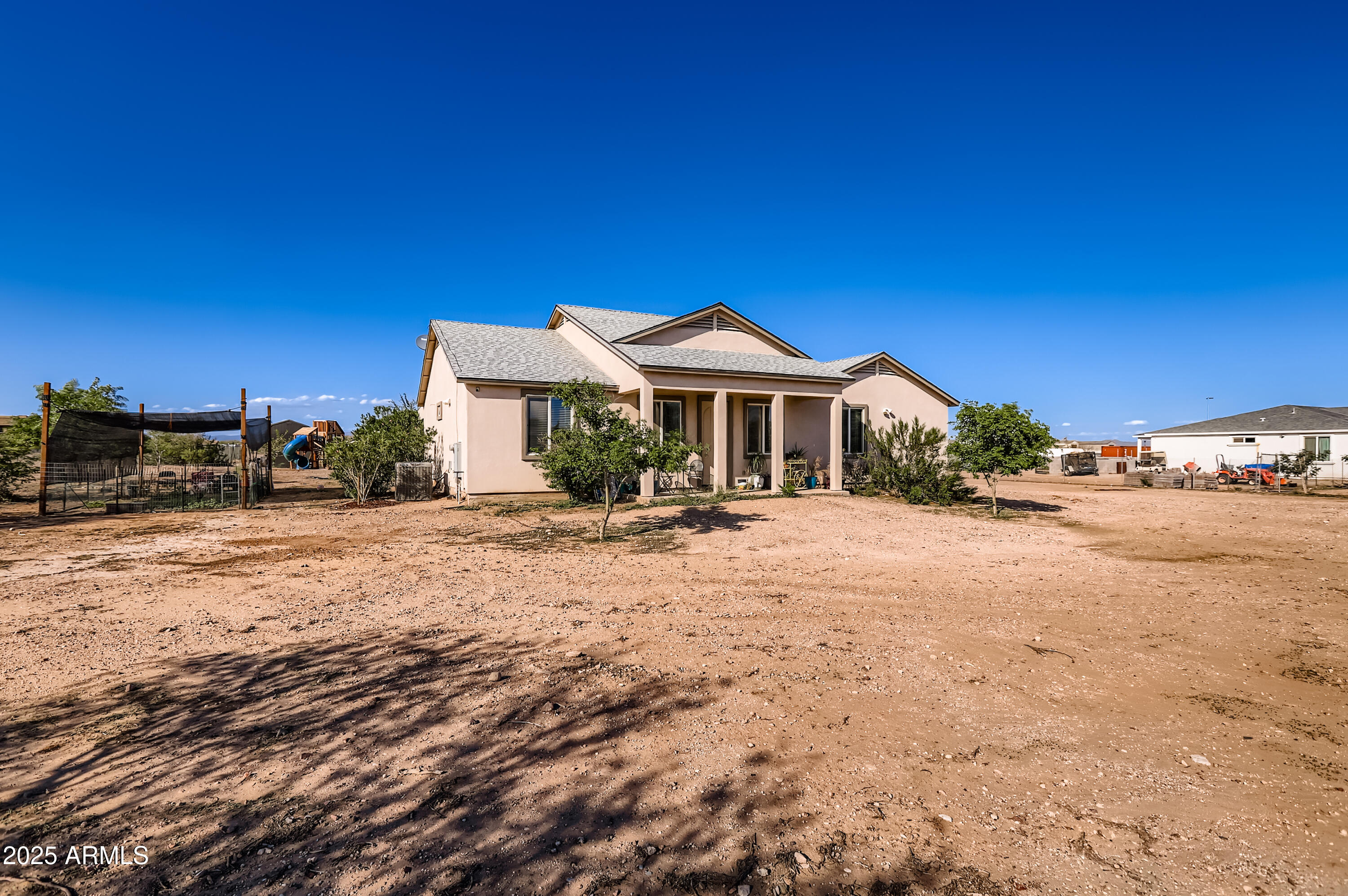 22136 West Gambit Trail Wittmann, AZ 85361 - Photo 2 of 38 a front view of a house with a yard