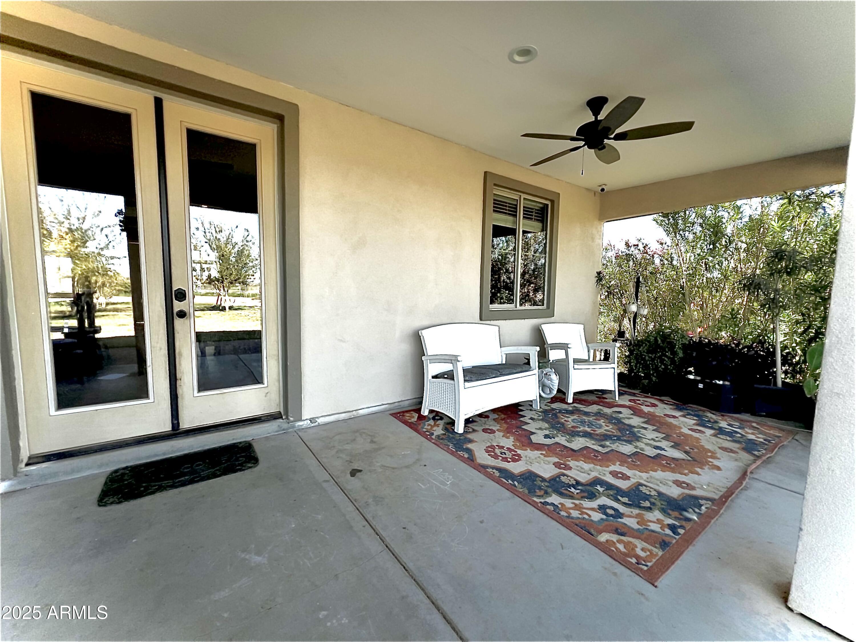 22136 West Gambit Trail Wittmann, AZ 85361 - Photo 25 of 38 a living room with a rug floor to ceiling window and a table