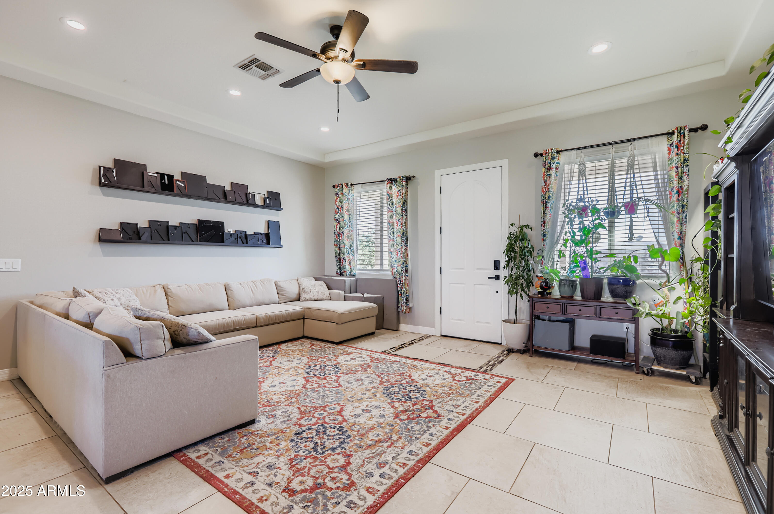 22136 West Gambit Trail Wittmann, AZ 85361 - Photo 4 of 38 a living room with furniture and a potted plant