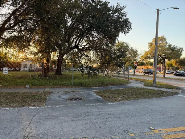 a backyard of apartments with large trees