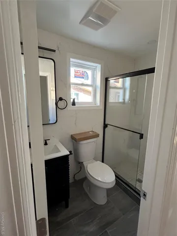 a white toilet sitting next to a bathroom sink