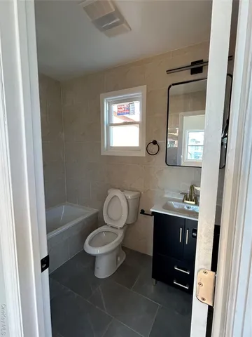 a bathroom with a toilet a sink and bathtub