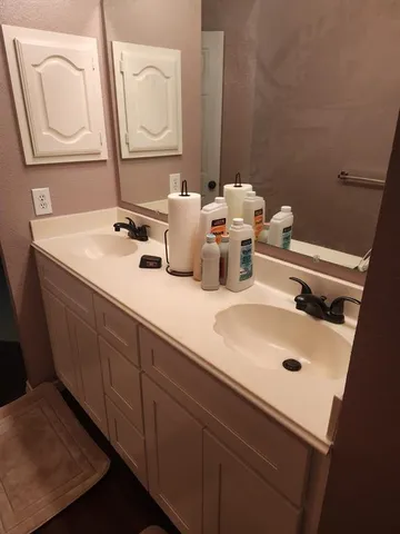 a bathroom with a toilet sink and mirror