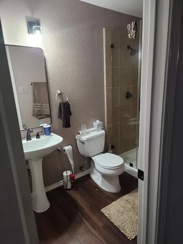 a bathroom with a sink a mirror and a toilet