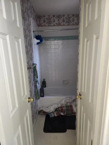 a living room with lots of furniture and a lamp