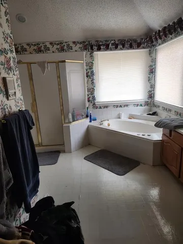 a kitchen with stainless steel appliances granite countertop a stove and a view of living room
