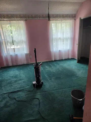 a bedroom with a bed chair and dresser