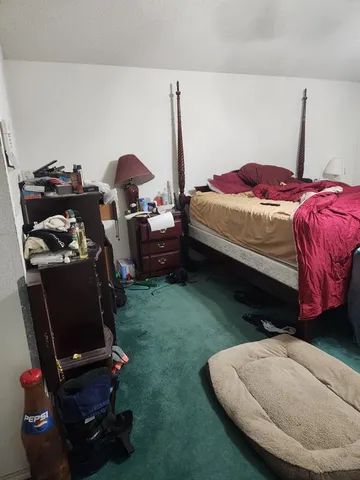 a bed sitting in a room next to a window