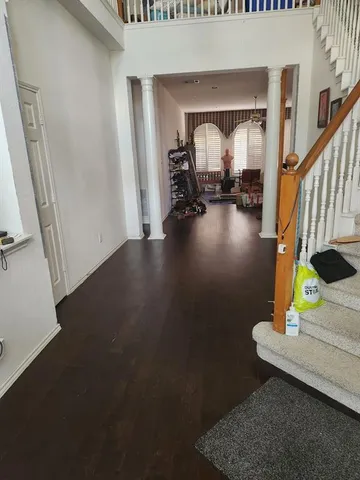 a living room with fireplace furniture and a large window