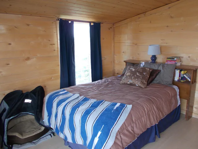 a bedroom with a bed and window