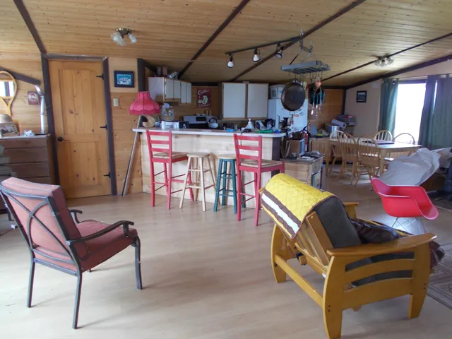 a living room with furniture and a kitchen