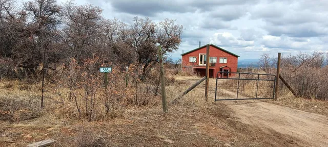 a view of house with a yard
