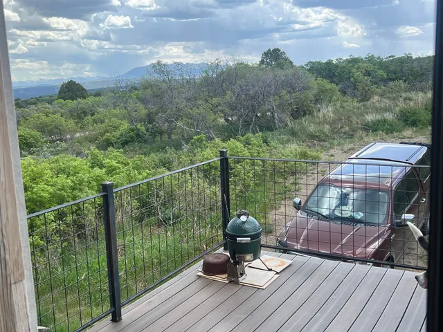 a view of a balcony with mountain view and wooden floor