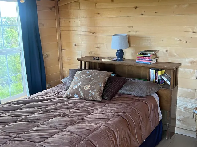 a bedroom with a bed and a window