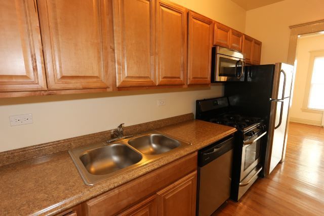 4716 North Racine Avenue, Unit 2E Chicago, IL 60640 - Photo 3 of 19 a kitchen with stainless steel appliances a sink a stove and a refrigerator