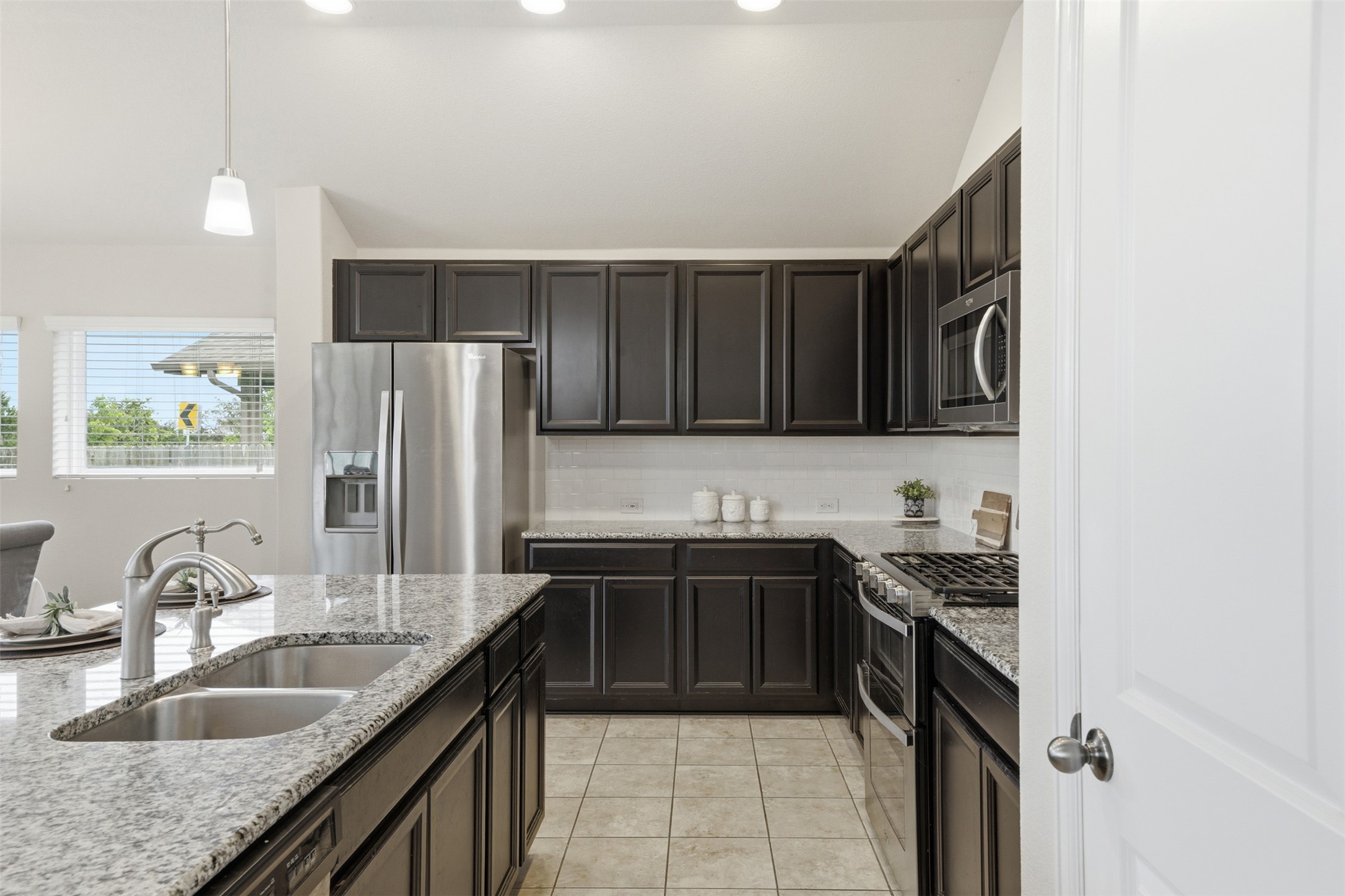 276 Gunnison Way Kyle, TX 78640 - Photo 27 of 28 a kitchen with a sink stove and refrigerator