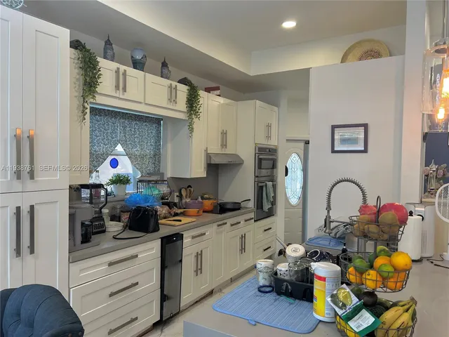 a kitchen with a sink appliances and cabinets