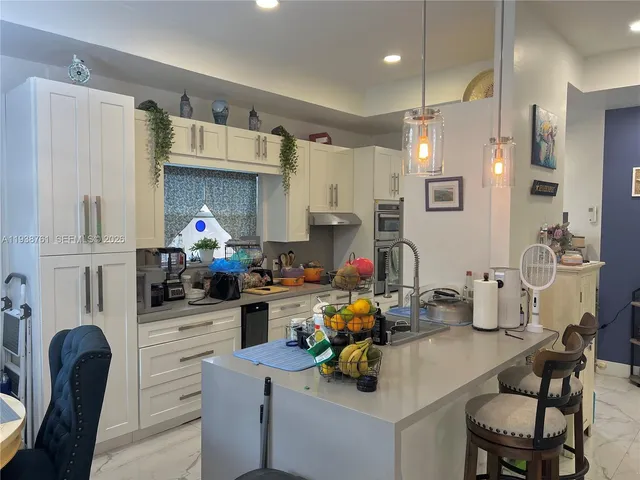 a kitchen with a sink cabinets and wooden floor