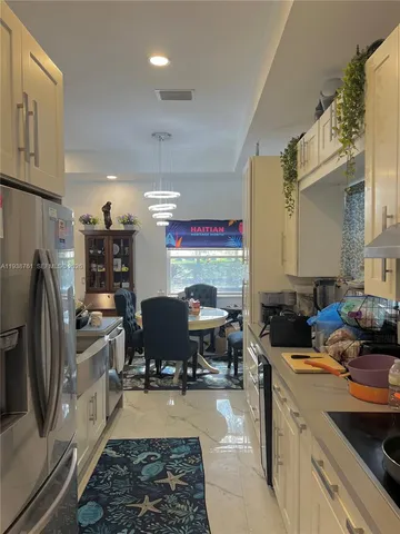 a kitchen with a sink appliances and cabinets