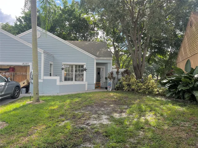 a view of a house with a backyard