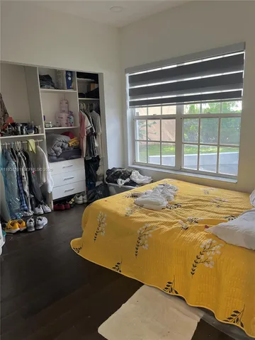 a bed sitting in a room next to a window