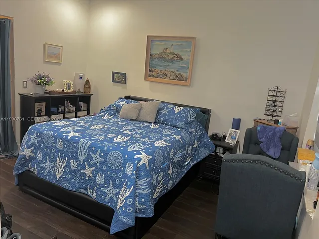 a bed sitting in a bedroom and chair