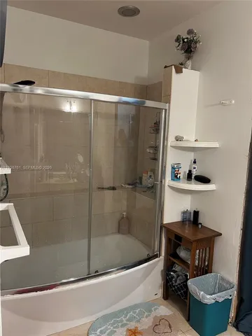 a bathroom with a bathtub and a shower