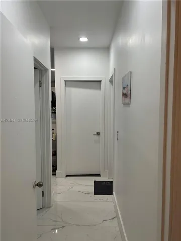 a view of a house with backyard and a large tree