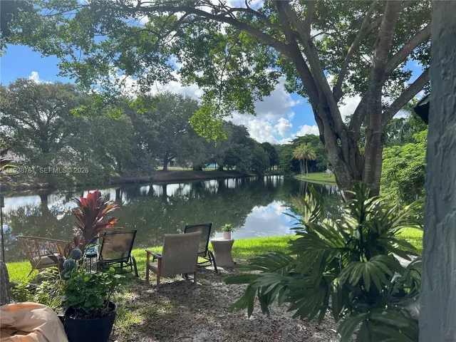 a backyard of a house with a yard and outdoor seating