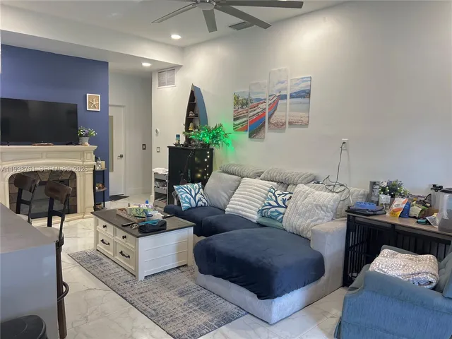 a living room with furniture fireplace and flat screen tv