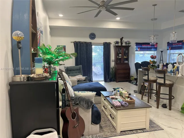 a living room with furniture and a potted plant