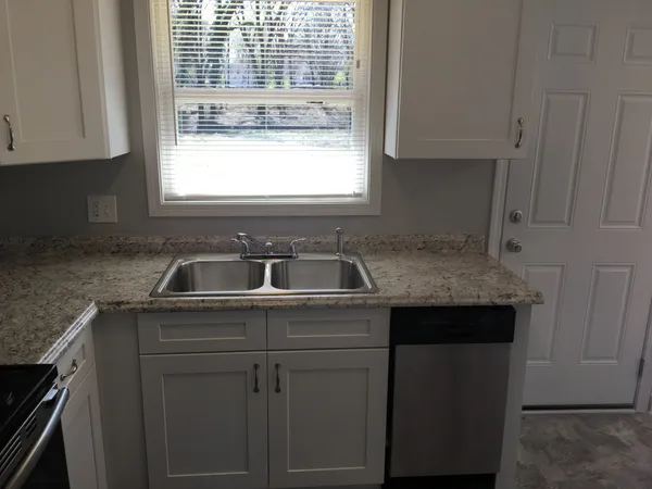 a kitchen with a sink stove and cabinets