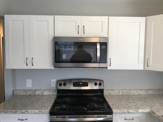 a kitchen with a sink stove and microwave