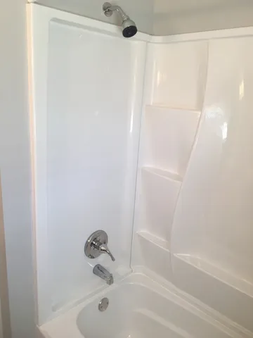 a bathroom with a toilet sink vanity and window