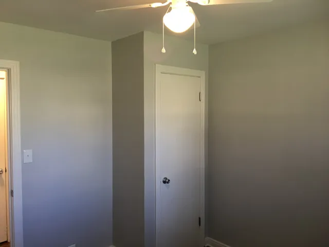 a view of hallway with wooden floor