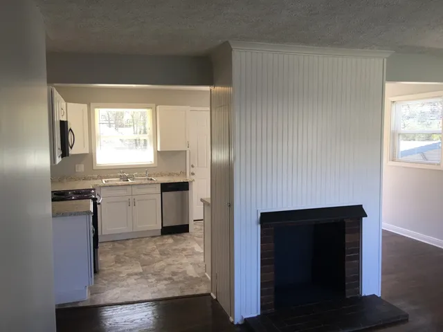 a kitchen with a refrigerator and a sink