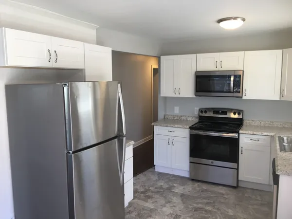 a kitchen with a refrigerator stove and microwave