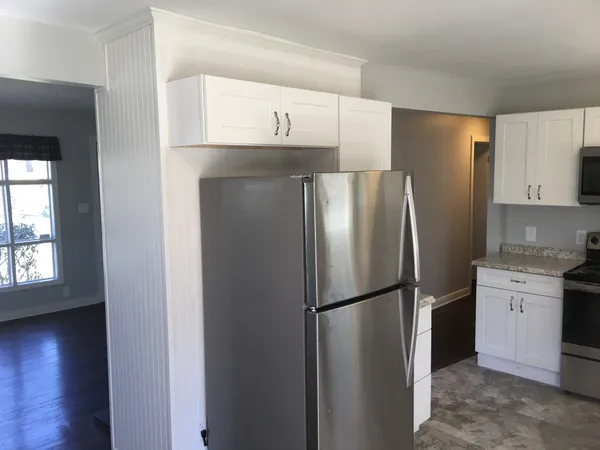 a metallic refrigerator freezer sitting in a kitchen