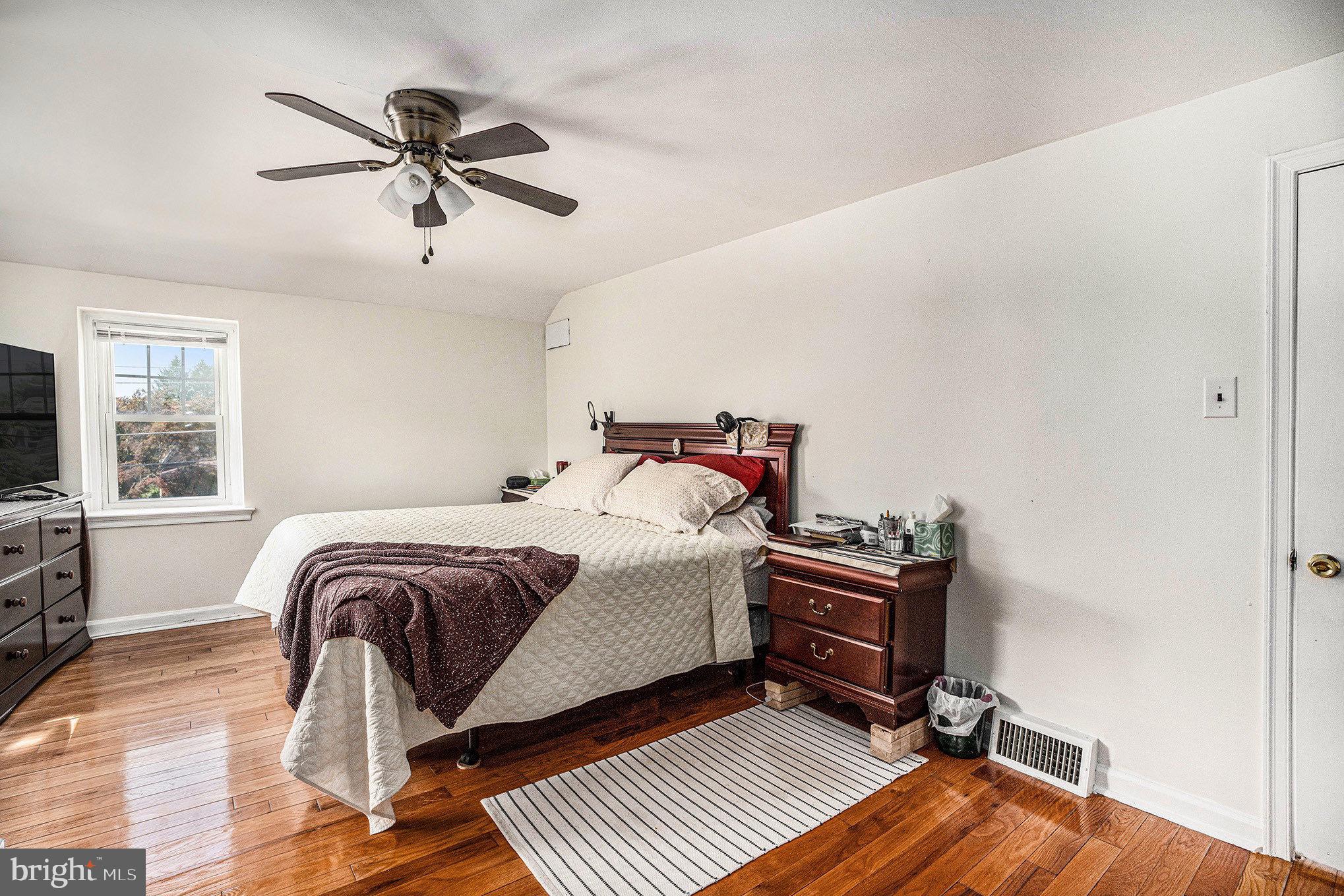 2209 East County Line Road Ardmore, PA 19003 - Photo 13 of 28 a bedroom with a bed and wooden floor