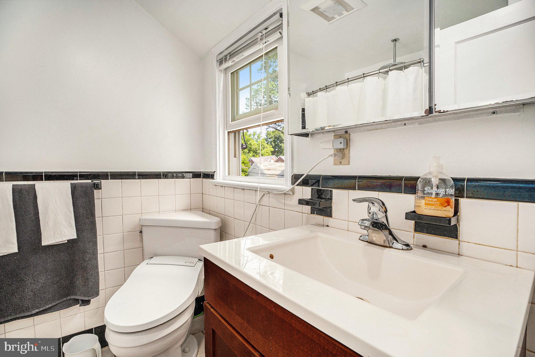 2209 East County Line Road Ardmore, PA 19003 - Photo 15 of 28 a bathroom with a sink a toilet and a window