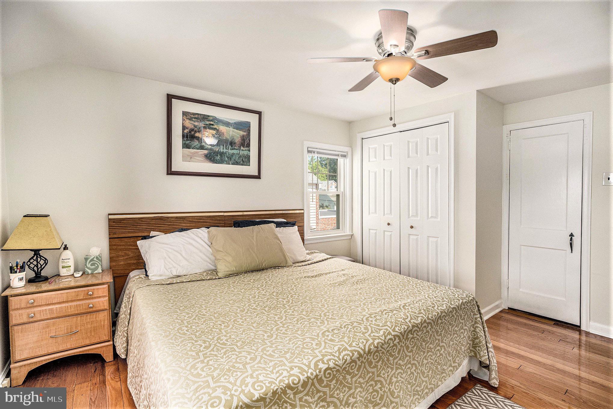 2209 East County Line Road Ardmore, PA 19003 - Photo 17 of 28 a bedroom with a bed and a chandelier
