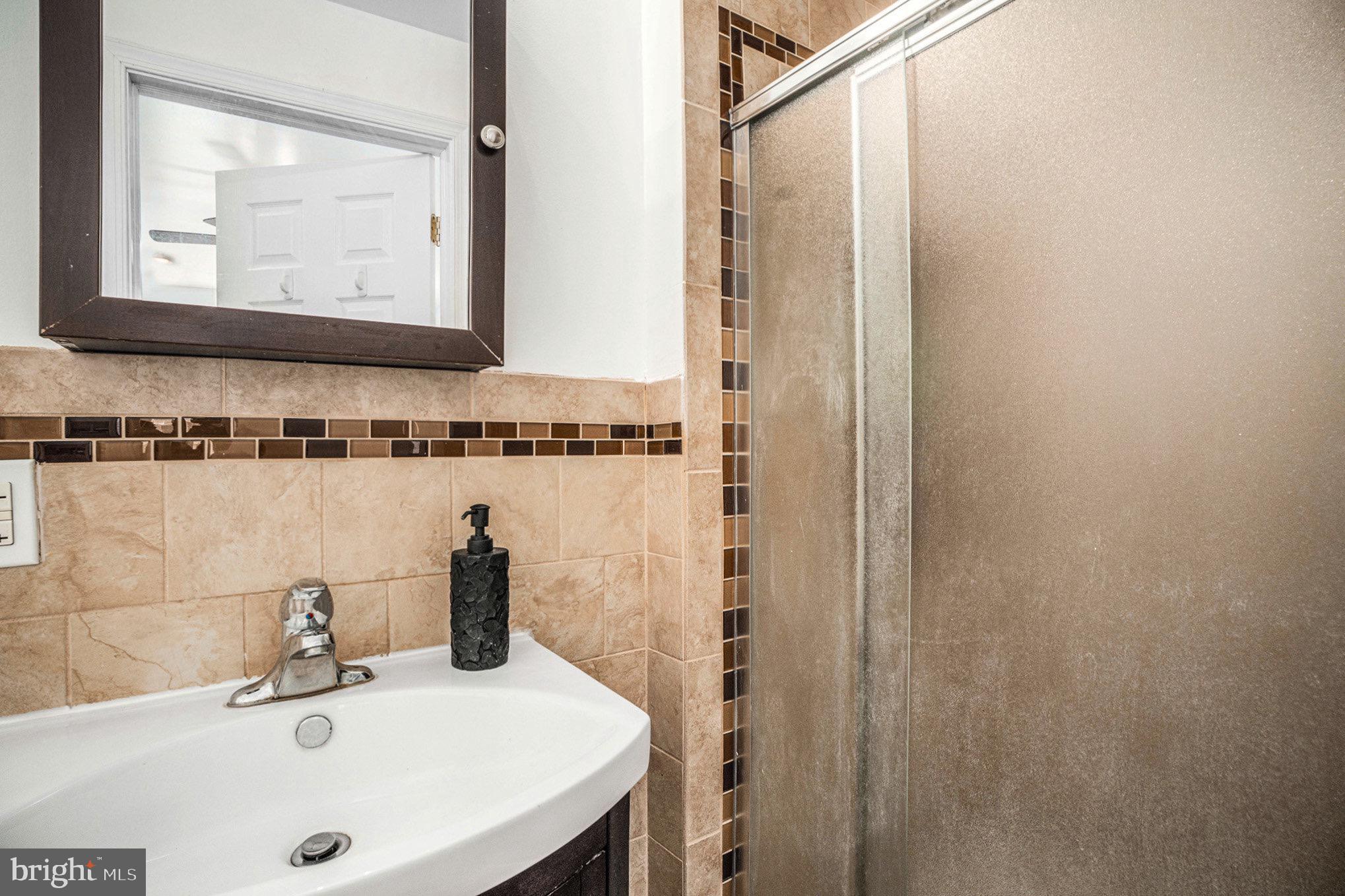 2209 East County Line Road Ardmore, PA 19003 - Photo 18 of 28 a bathroom with a sink and a mirror