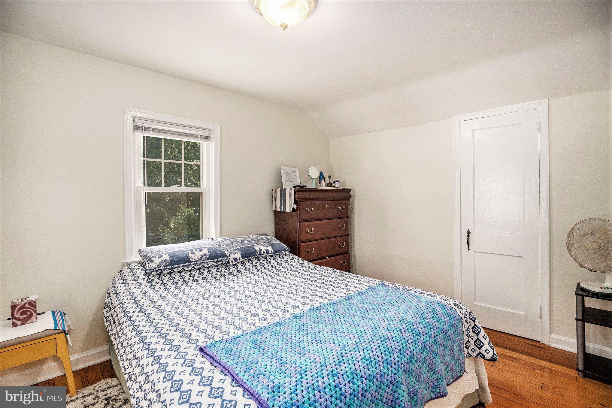 2209 East County Line Road Ardmore, PA 19003 - Photo 20 of 28 a bedroom with a bed and wooden floor