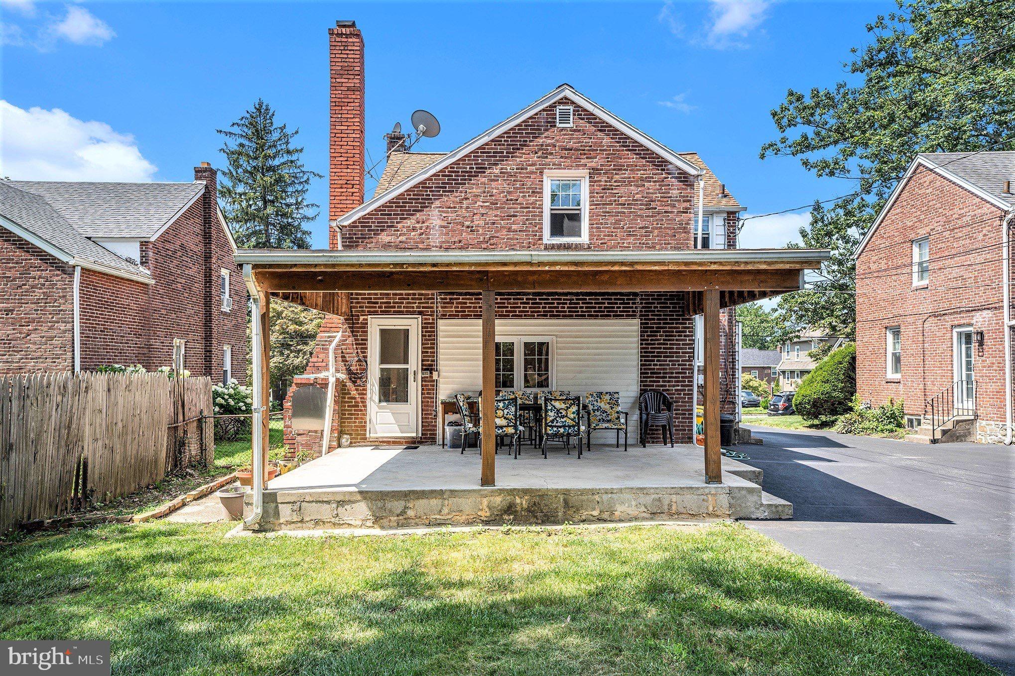 2209 East County Line Road Ardmore, PA 19003 - Photo 25 of 28 a front view of a house with a yard table and chairs
