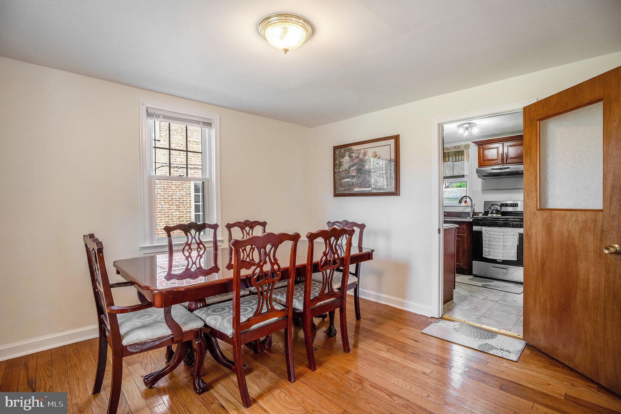 2209 East County Line Road Ardmore, PA 19003 - Photo 8 of 28 a view of a dining room with furniture and wooden floor
